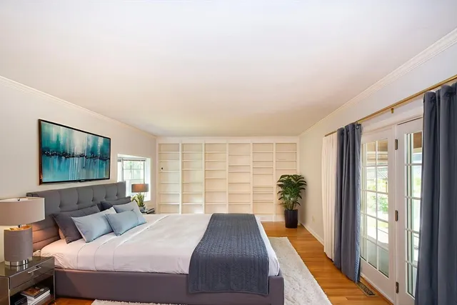 a bedroom with a large bed and a large window