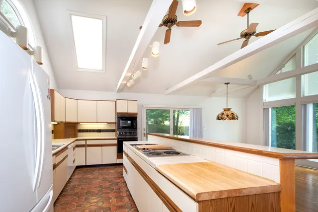 a kitchen with a refrigerator and window