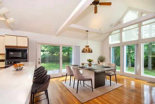 a view of a dining room with furniture large windows and wooden floor