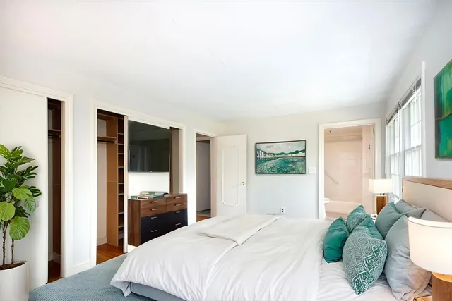 a bedroom with a bed and a large window