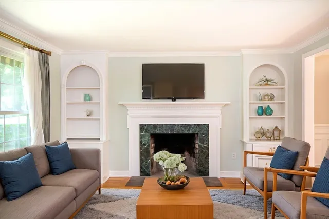a living room with furniture a window and a fireplace
