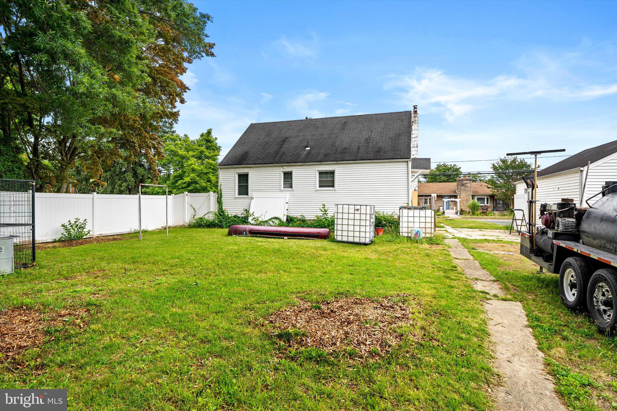 319 Station Road Roebling, NJ 08554 - Photo 15 of 15 a view of a white house in front of a big yard with potted plants and large trees