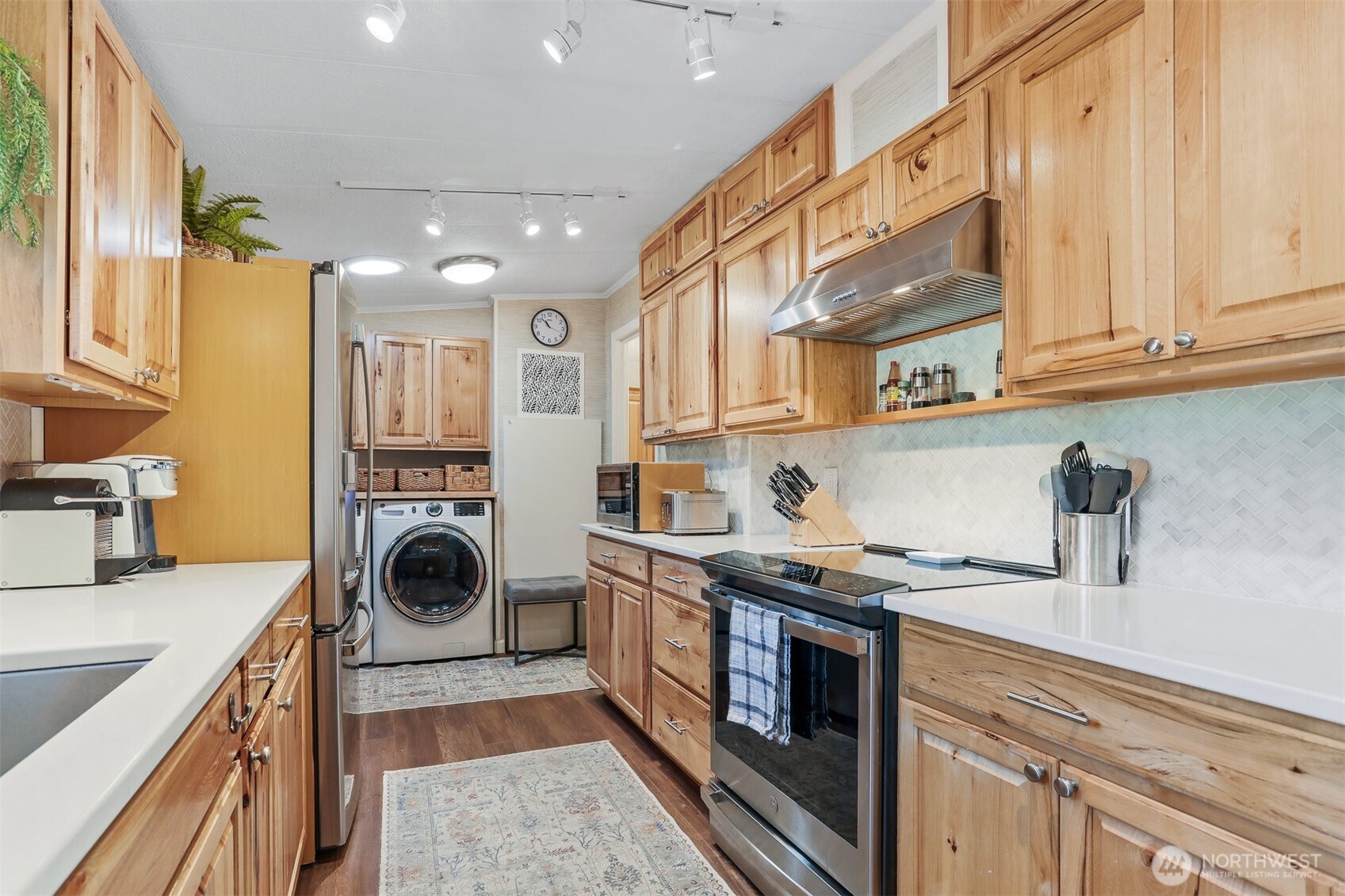 23716 9th Place West Bothell, WA 98021 - Photo 18 of 40 a kitchen with a stove top oven sink and cabinets