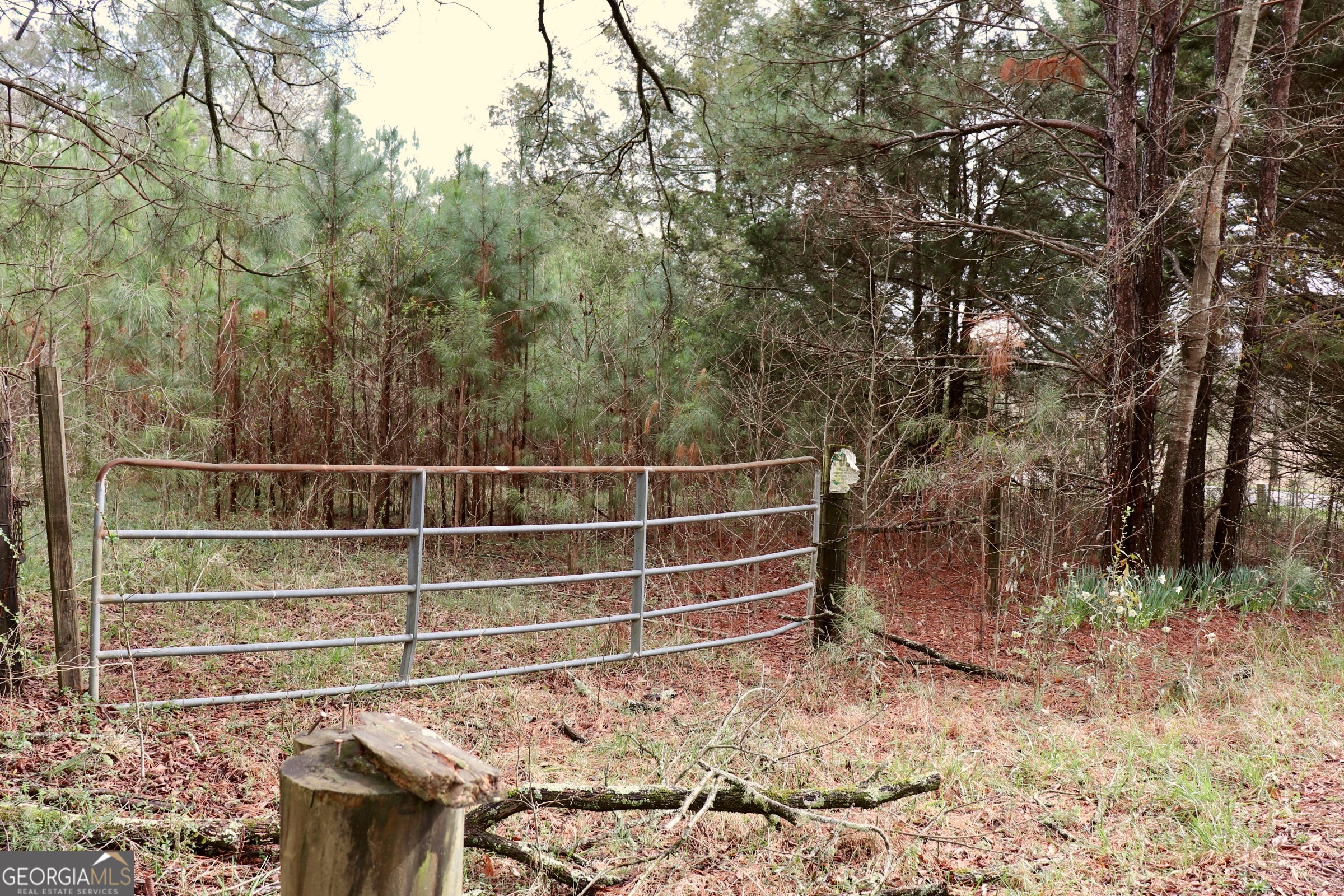 a view of a wooden fence and trees