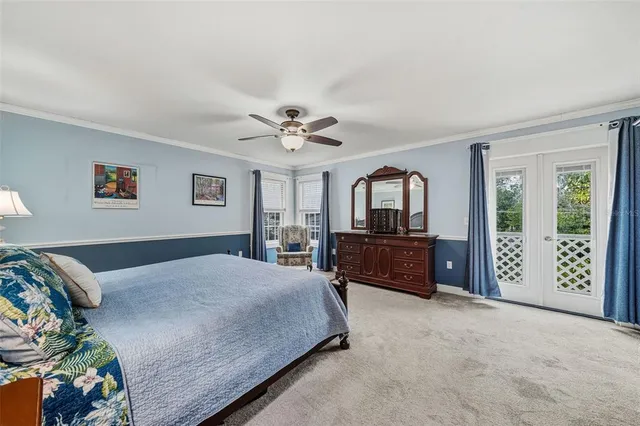 a living room with a bed furniture and a large window
