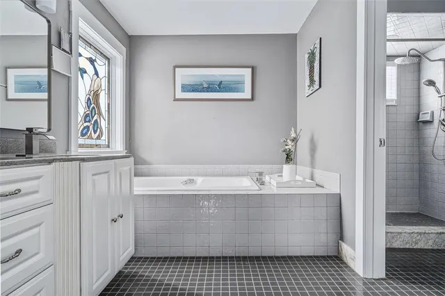 a bathroom with a bathtub sink and mirror