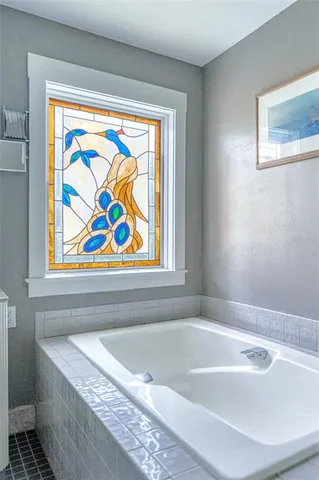 a bath tub sitting next to a window