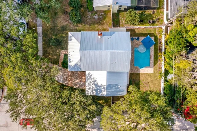 an aerial view of a house with a yard and garden