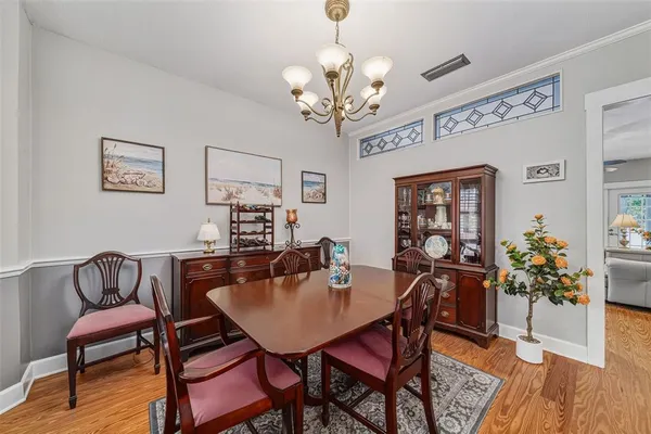 a view of a dining room with furniture and wooden floor