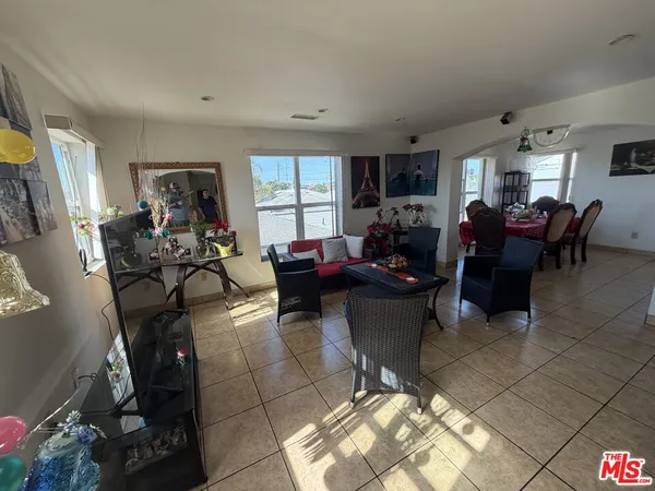 a living room with furniture a window and a flat screen tv