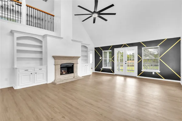 a view of an empty room with a fireplace and a window