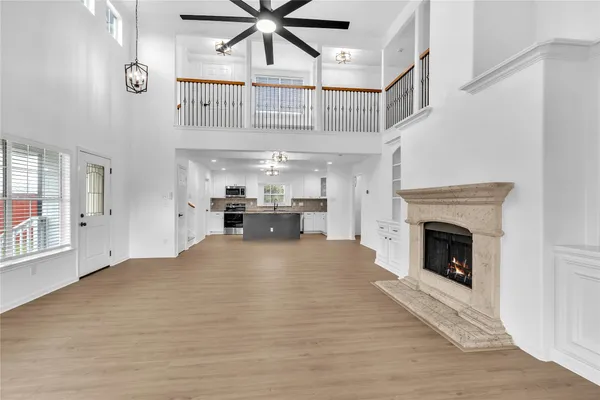 a view of an empty room and kitchen view