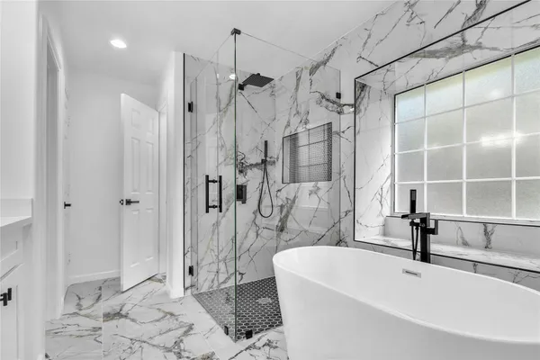 a bathroom with a bathtub and a shower