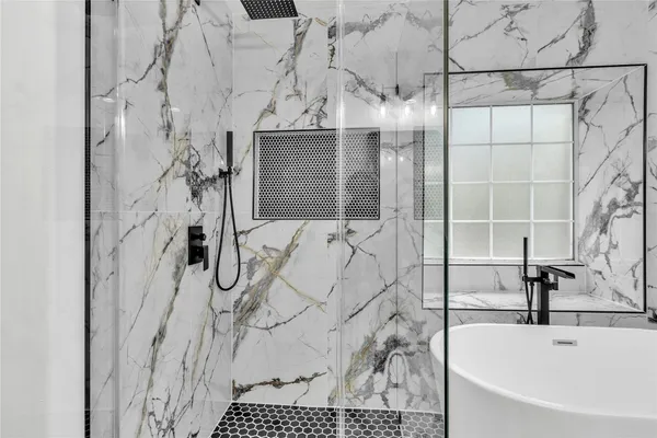 a bathroom with a bathtub and shower