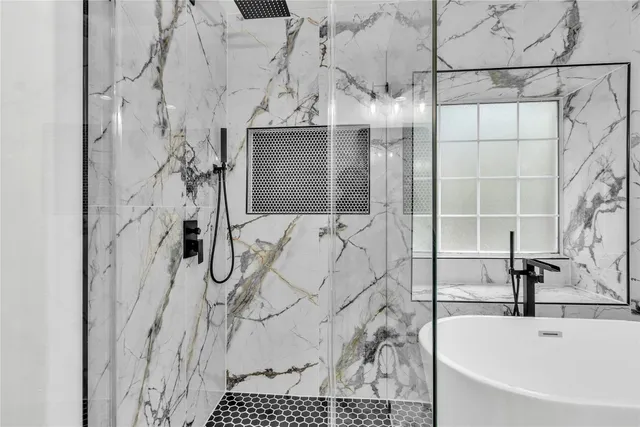 a bathroom with a bathtub and shower