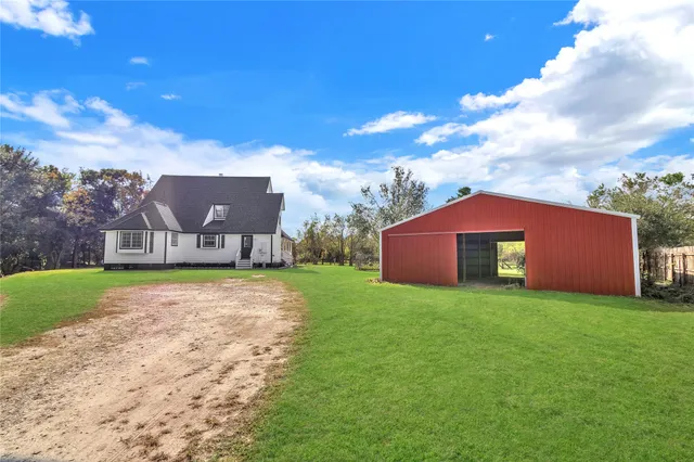 a view of a big house with a big yard
