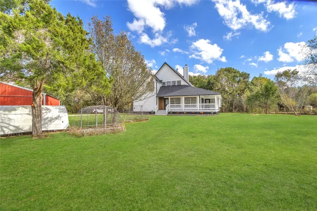 a front view of house with a garden