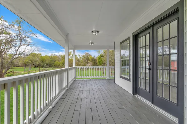 a view of a room with wooden floor and balcony