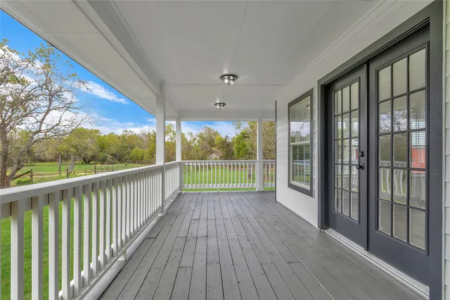 a view of a room with wooden floor and balcony