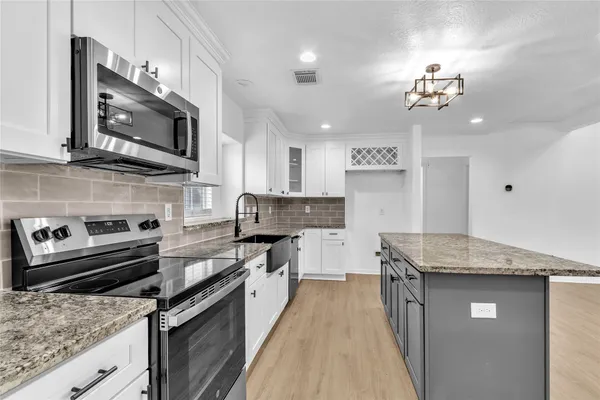 a kitchen with a stove and a sink