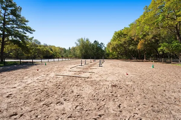 a front view of a house with garden and trees
