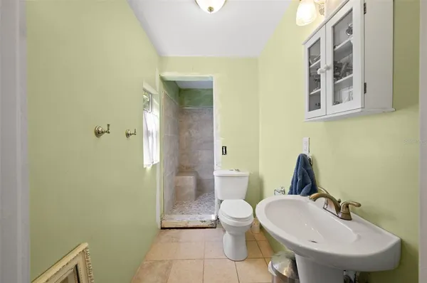 a kitchen with stainless steel appliances kitchen island granite countertop a stove top oven a sink dishwasher a dining table and chairs with wooden floor