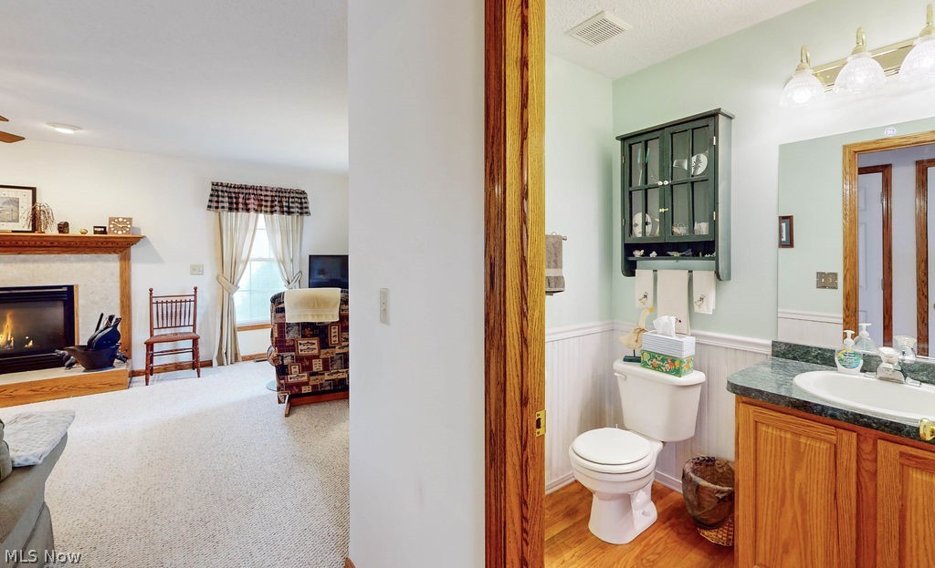 10147 Page Road Streetsboro, OH 44241 - Photo 15 of 35 Bathroom featuring toilet, vanity, ceiling fan, and hardwood / wood-style flooring