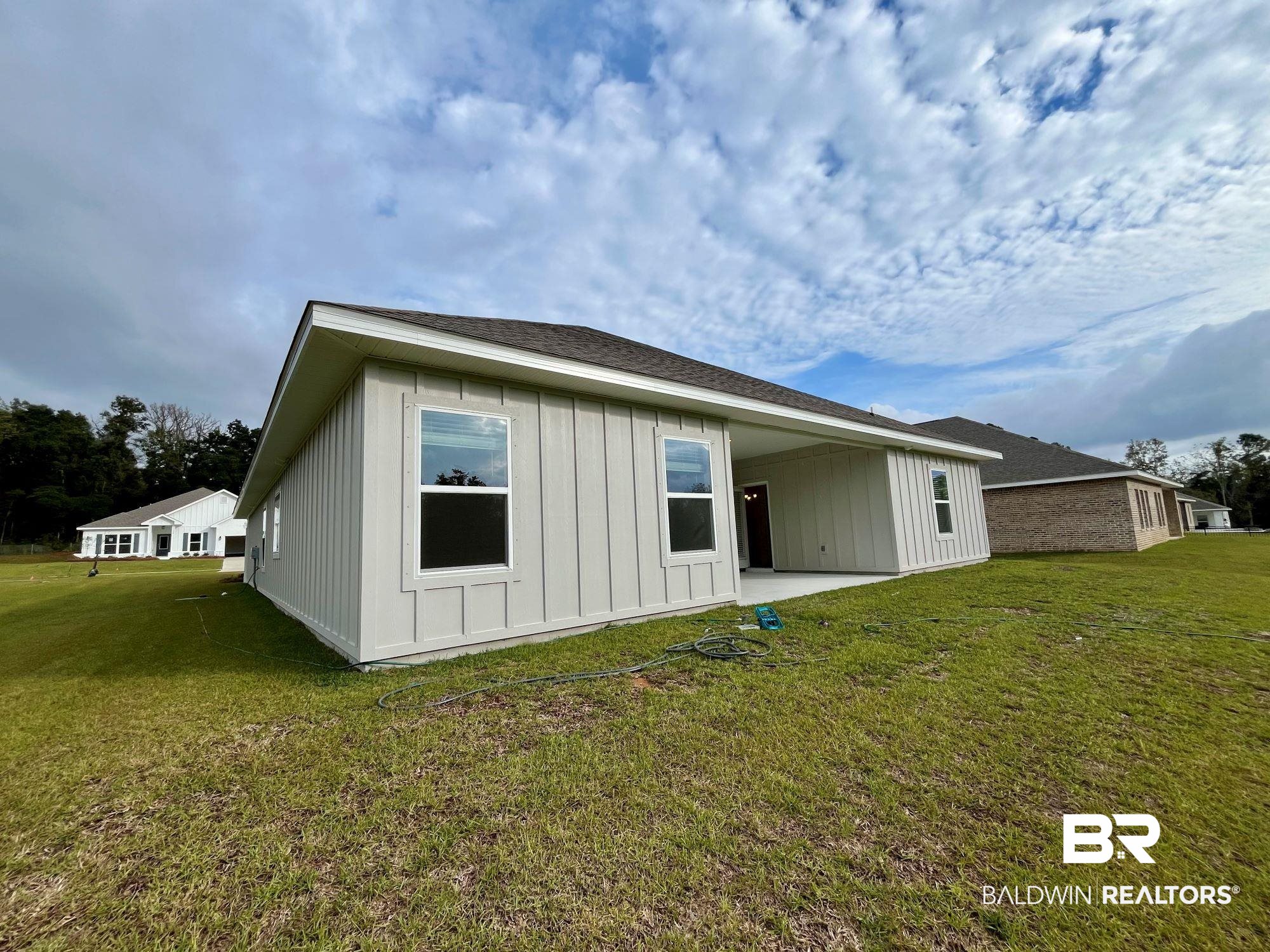 337 Barndling Street Fairhope, AL 36532 - Photo 30 of 34 Rear view of property featuring a lawn and a patio area