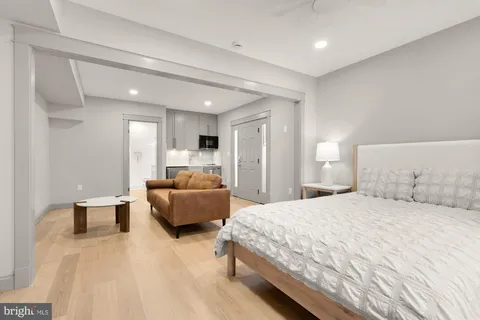 a spacious bedroom with a bed and couch