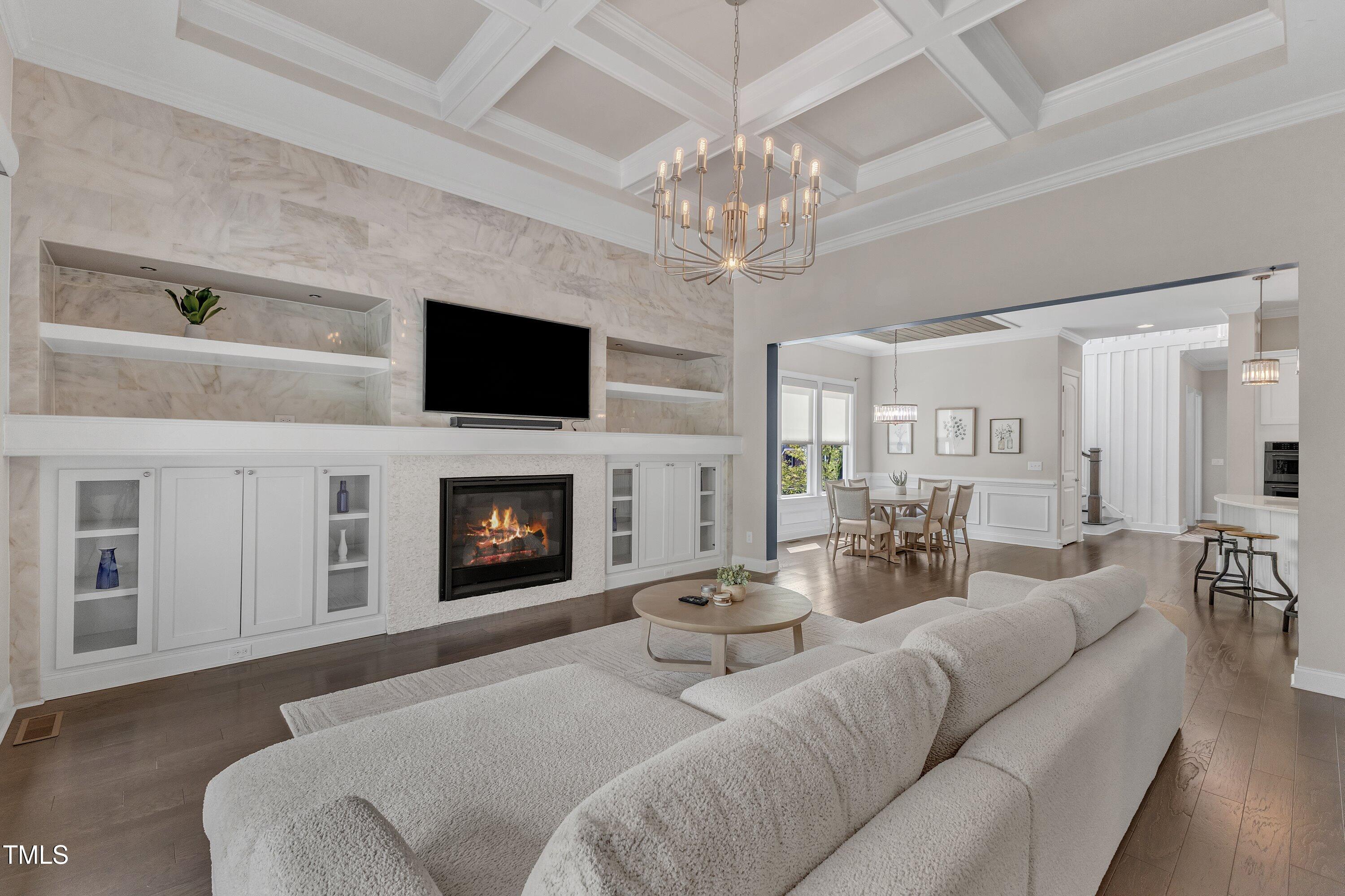 8121 Greys Landing Way Raleigh, NC 27615 - Photo 2 of 95 a living room with furniture a fireplace and a flat screen tv
