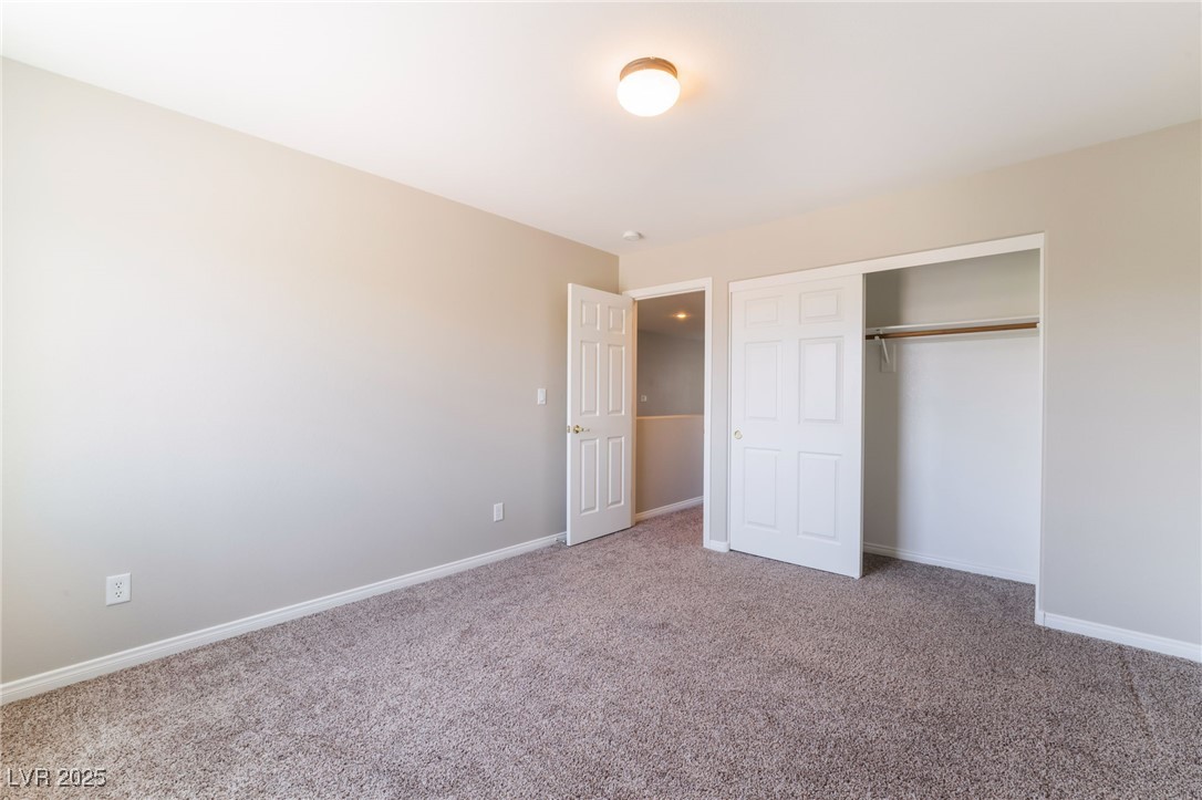 7857 Midnight Ride Street Las Vegas, NV 89131 - Photo 25 of 53 Unfurnished bedroom with carpet, baseboards, and a closet