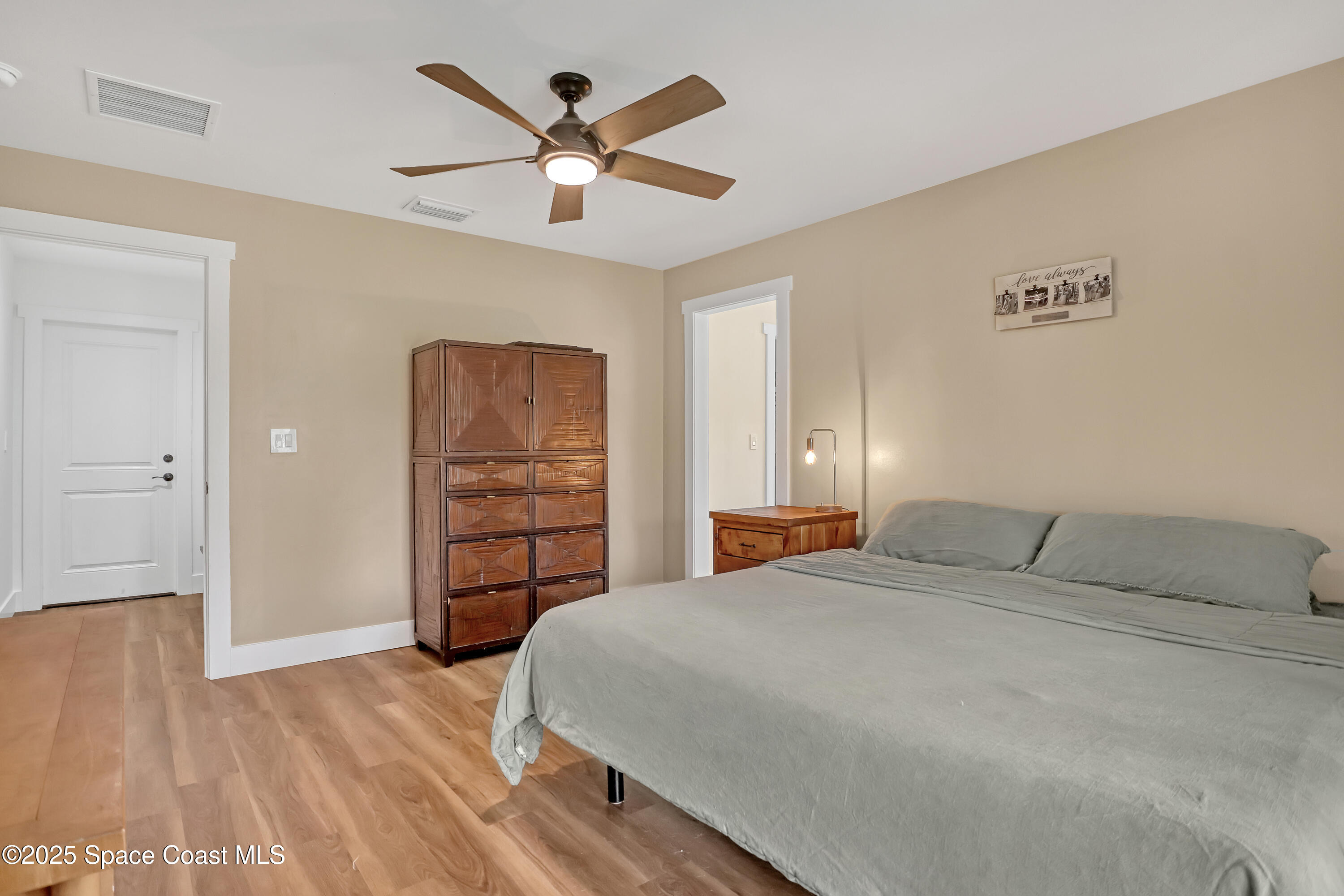 3350 Leghorn Road Malabar, FL 32950 - Photo 18 of 55 a bedroom with a bed and a chandelier