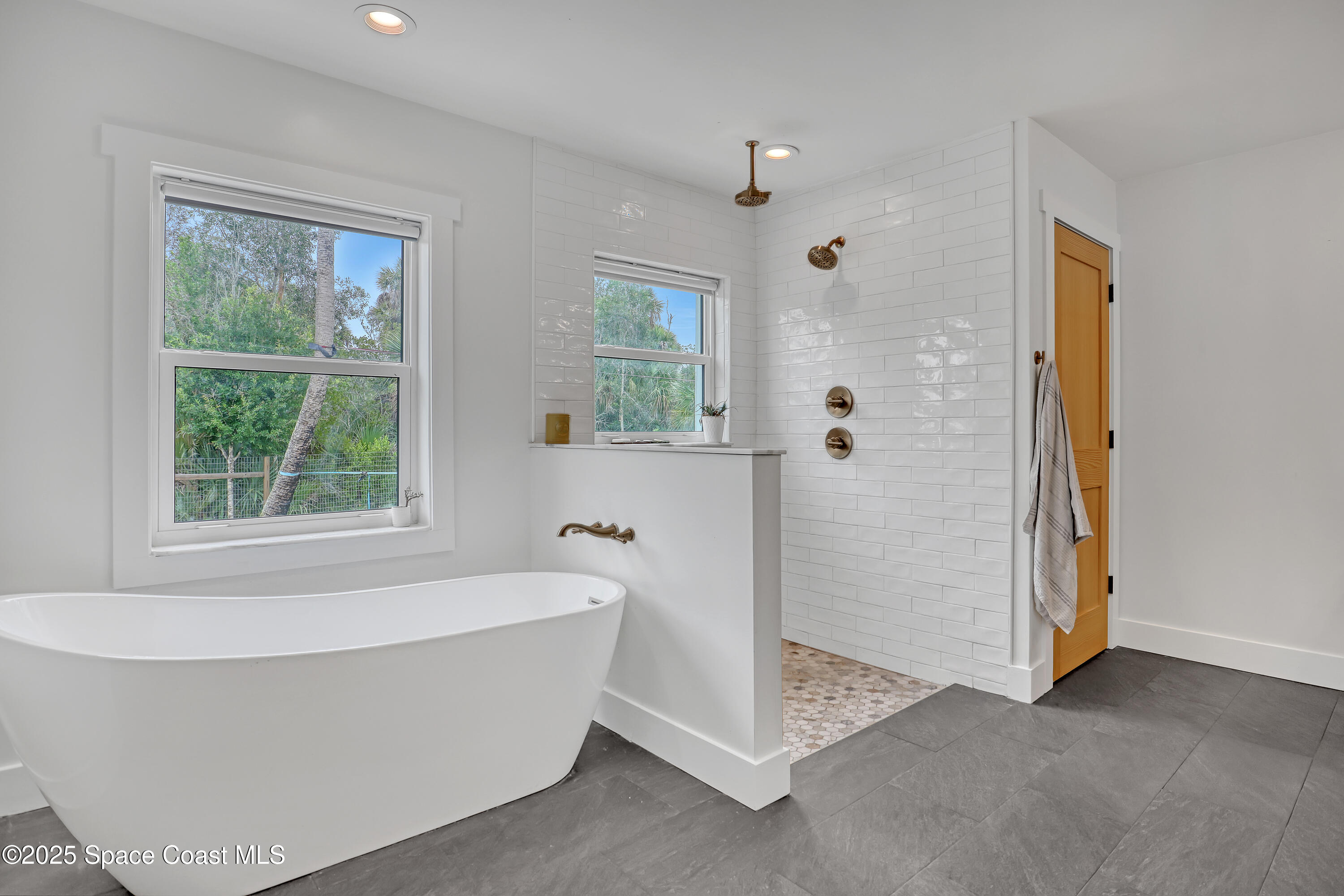 3350 Leghorn Road Malabar, FL 32950 - Photo 19 of 55 a bathroom with a bathtub and shower