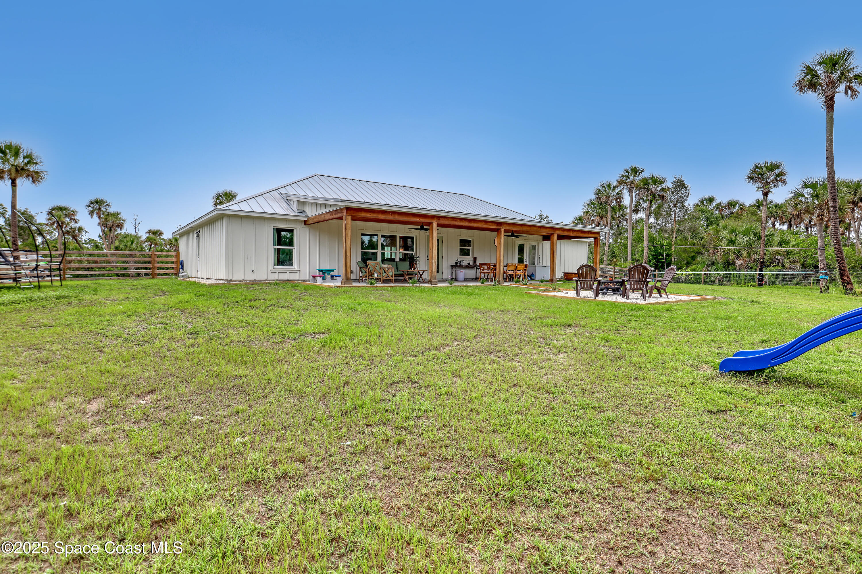 3350 Leghorn Road Malabar, FL 32950 - Photo 39 of 55 a view of a house with a big yard and potted plants