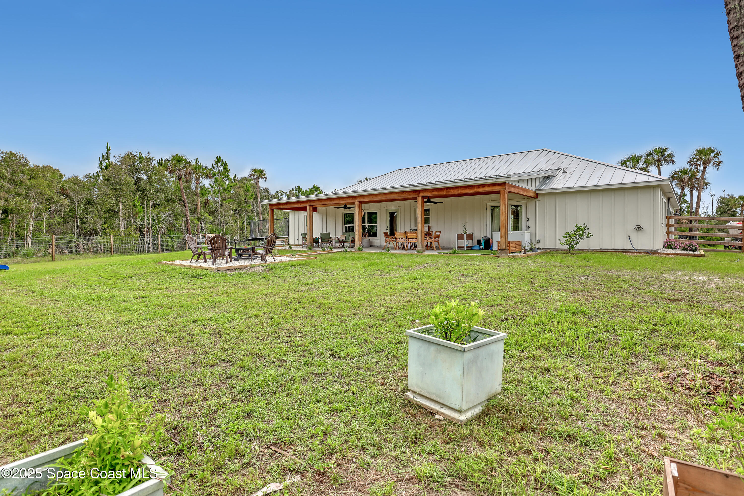 3350 Leghorn Road Malabar, FL 32950 - Photo 41 of 55 a white house with a yard and a fountain