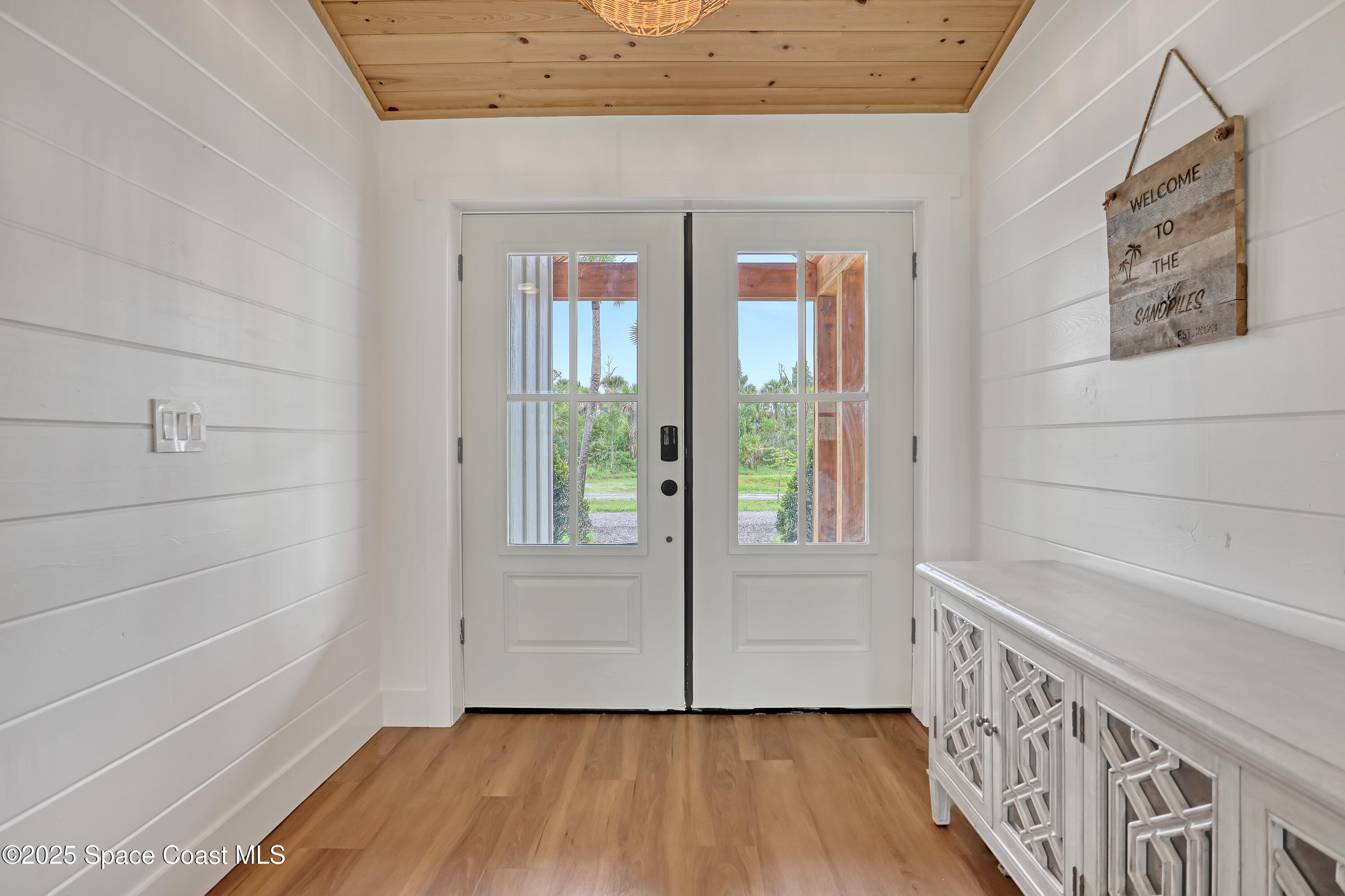 3350 Leghorn Road Malabar, FL 32950 - Photo 7 of 55 a view of an entryway with wooden floor and windows