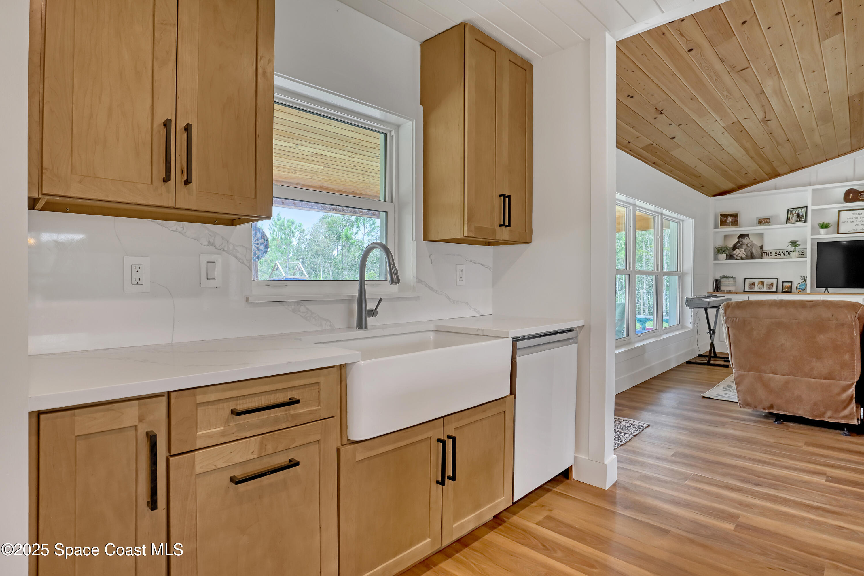 3350 Leghorn Road Malabar, FL 32950 - Photo 9 of 55 a kitchen with cabinets wooden floor and a window