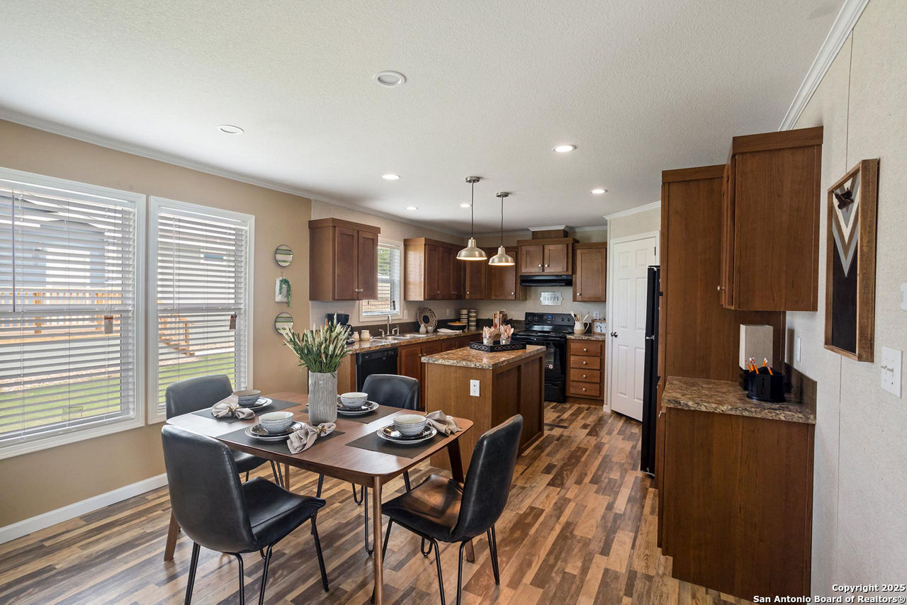 113 County Road 2644 Devine, TX 78057 - Photo 6 of 14 a view of a dining room with furniture a kitchen and chandelier