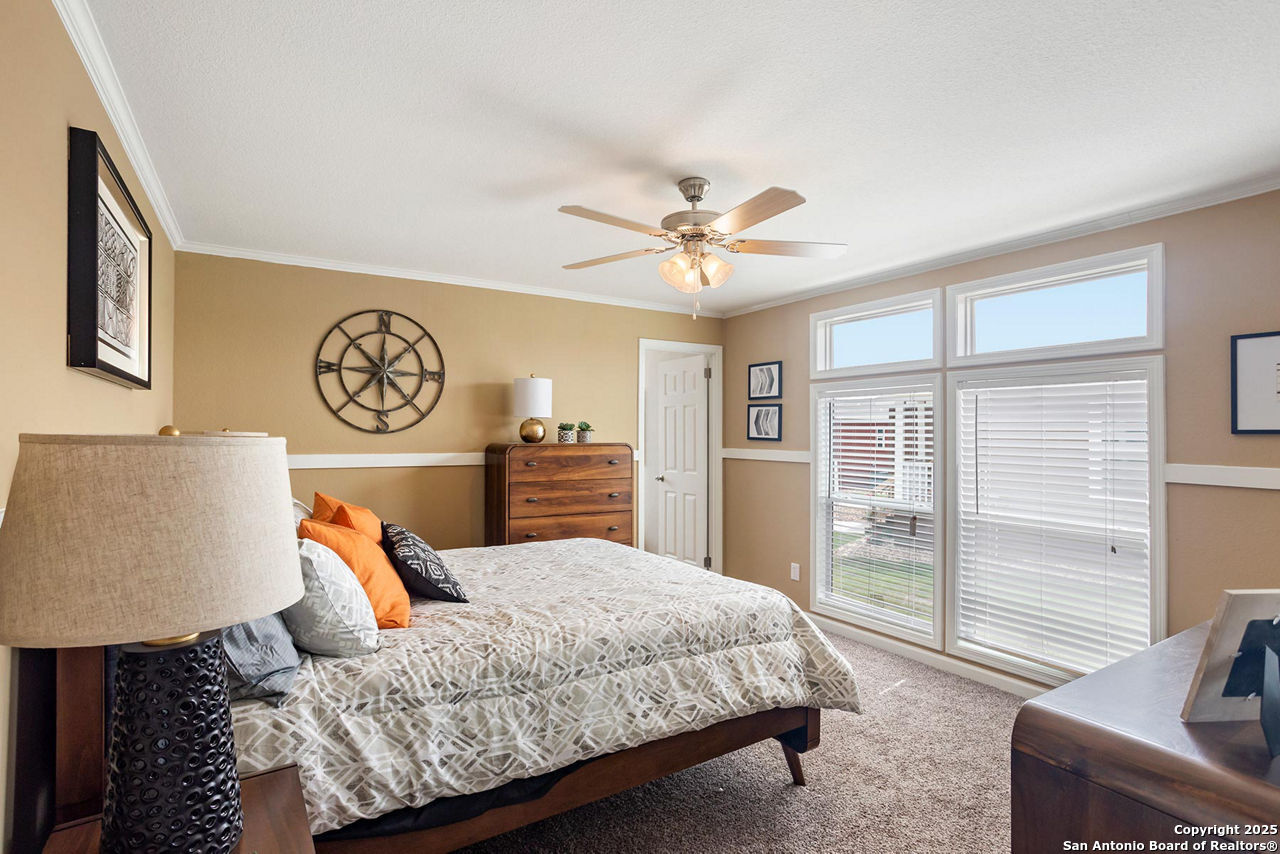 113 County Road 2644 Devine, TX 78057 - Photo 8 of 14 a bedroom with a large bed and a couch