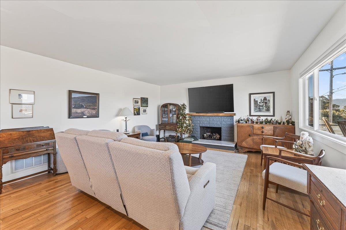 1232 Vallejo Street Seaside, CA 93955 - Photo 15 of 42 a living room with furniture a fireplace and a flat screen tv