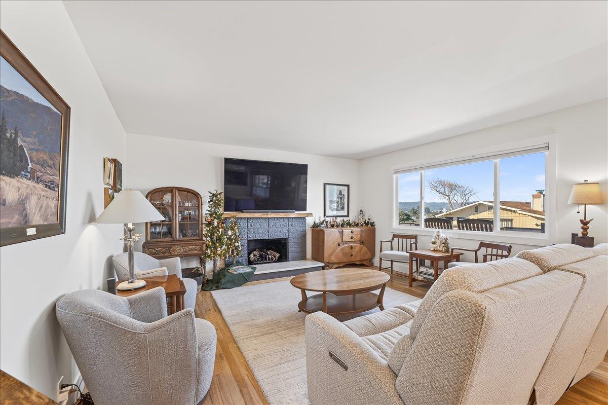 1232 Vallejo Street Seaside, CA 93955 - Photo 22 of 42 a living room with furniture fireplace and a flat screen tv