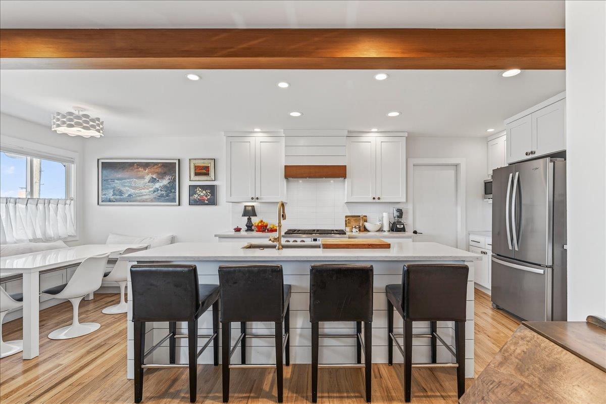 1232 Vallejo Street Seaside, CA 93955 - Photo 25 of 42 a kitchen with stainless steel appliances a dining table chairs and granite counter tops