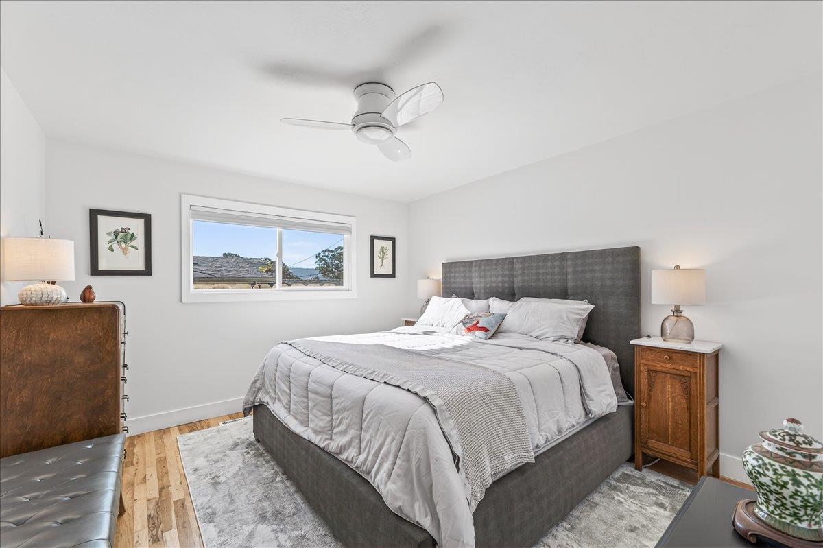 1232 Vallejo Street Seaside, CA 93955 - Photo 27 of 42 a bedroom with a bed and a painting on the wall