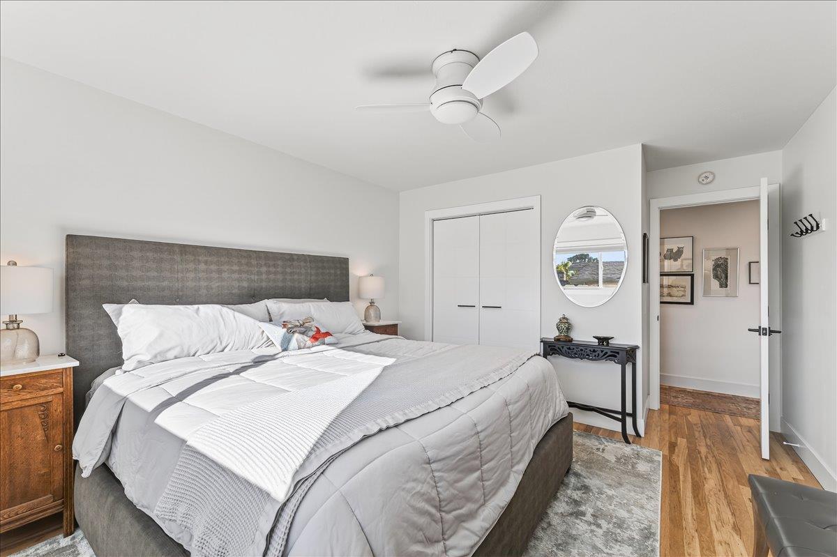 1232 Vallejo Street Seaside, CA 93955 - Photo 28 of 42 a bedroom with a bed and a chandelier