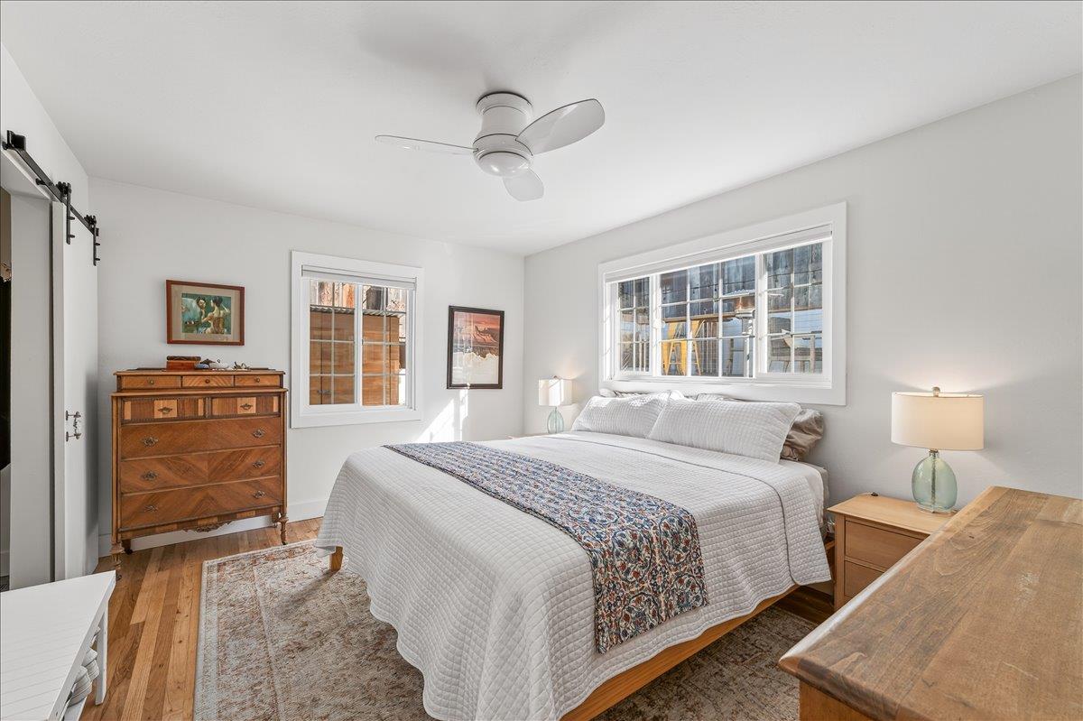 1232 Vallejo Street Seaside, CA 93955 - Photo 30 of 42 a spacious bedroom with a bed a dresser and large windows