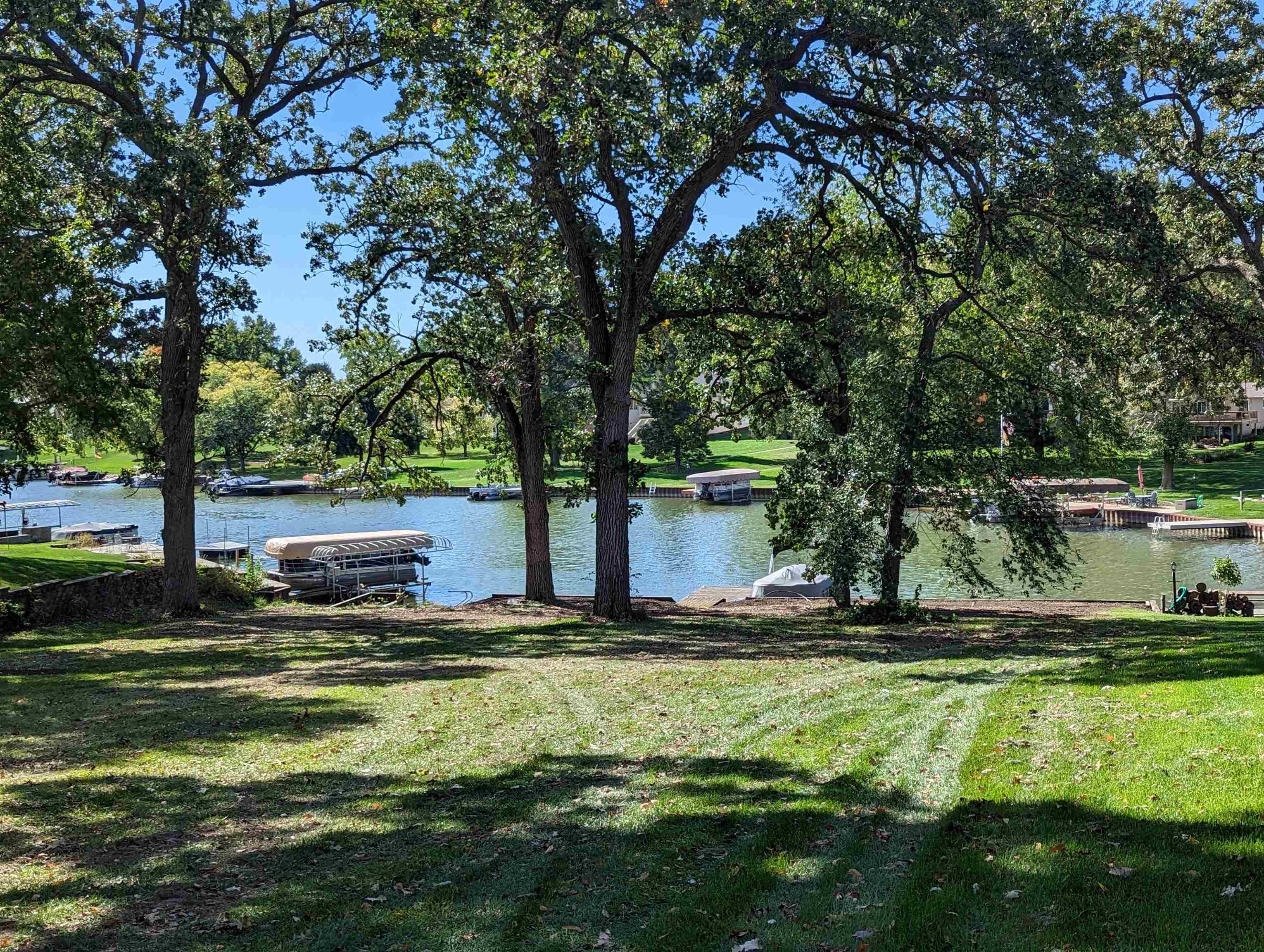 1408 Pier Drive Lake Summerset, IL 61019 - Photo 1 of 20 a view of pool with lawn chairs yard and large trees