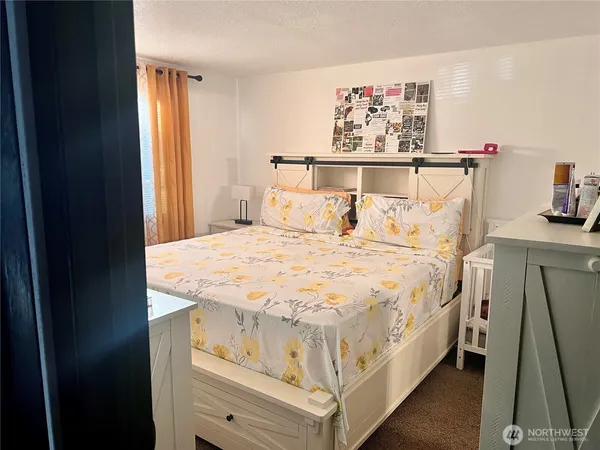 a bed sitting in a bedroom next to a window