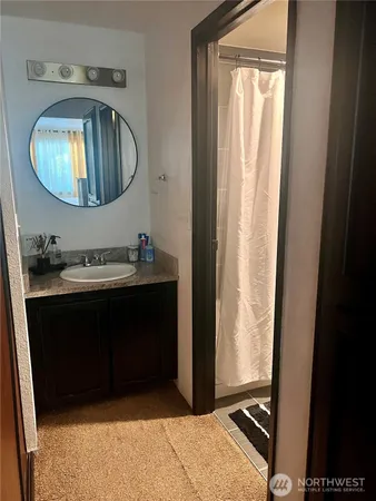 a bathroom with a sink vanity and a mirror