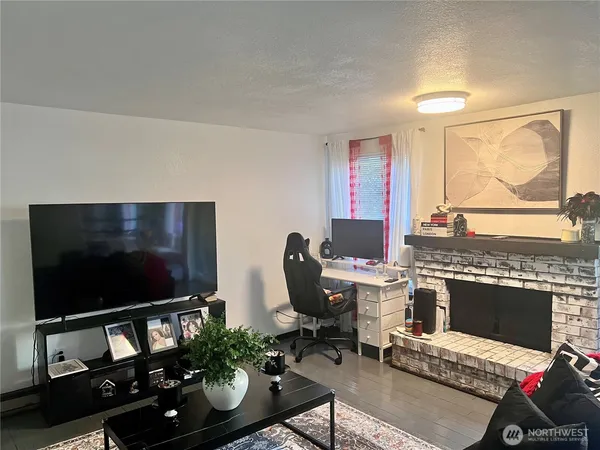 a living room with furniture a flat screen tv and a floor to ceiling window