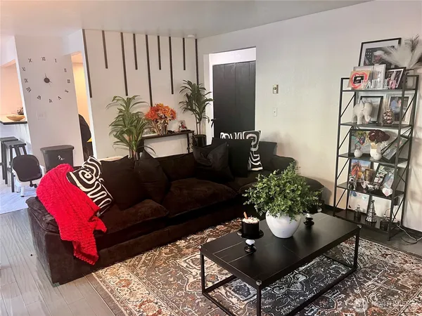 a living room with furniture flowerpot and a rug